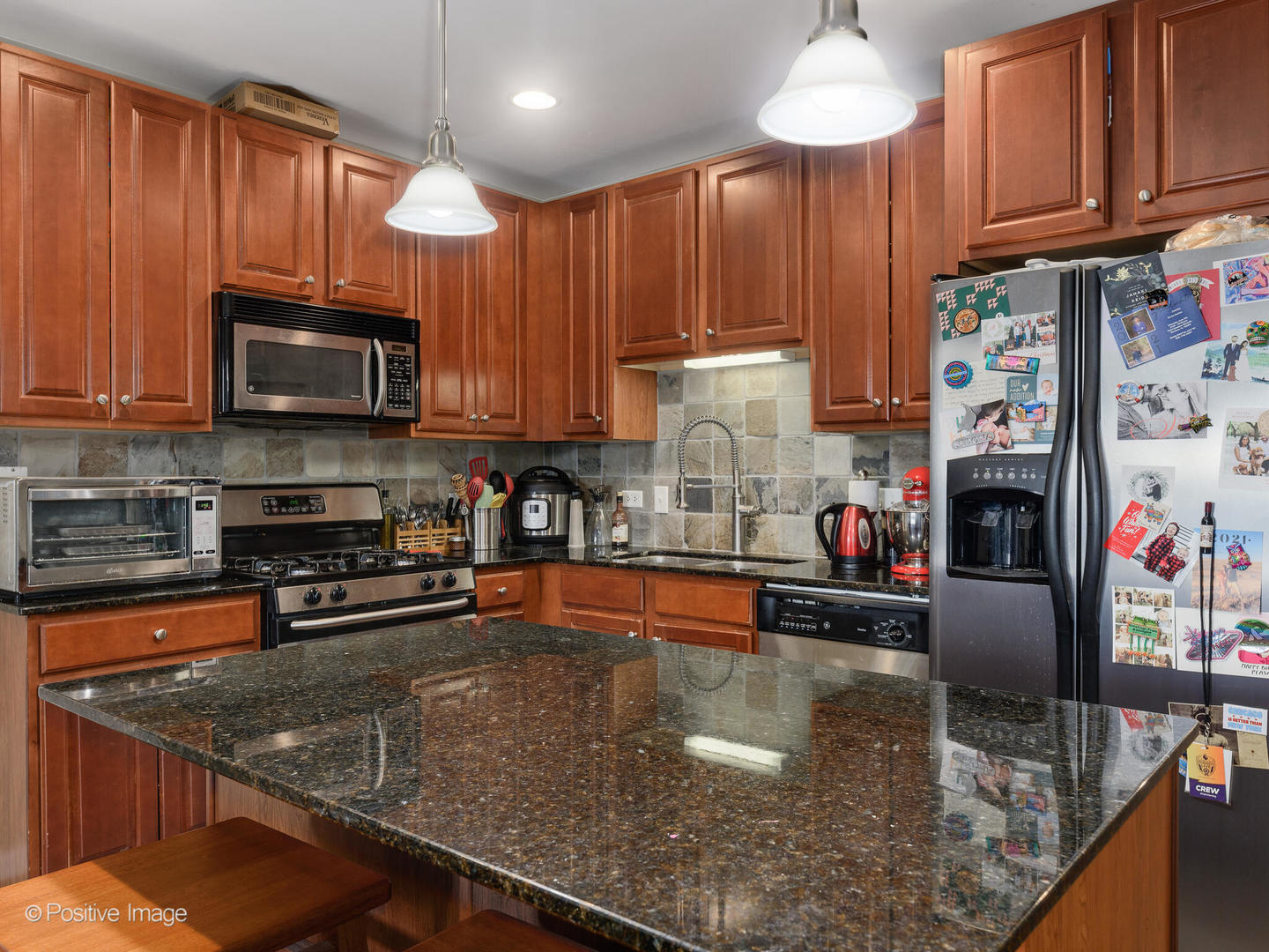 828 West Grace Street, Unit 508 Chicago, IL 60613 - Photo 3 of 15 a kitchen with stainless steel appliances granite countertop a sink a stove and a microwave