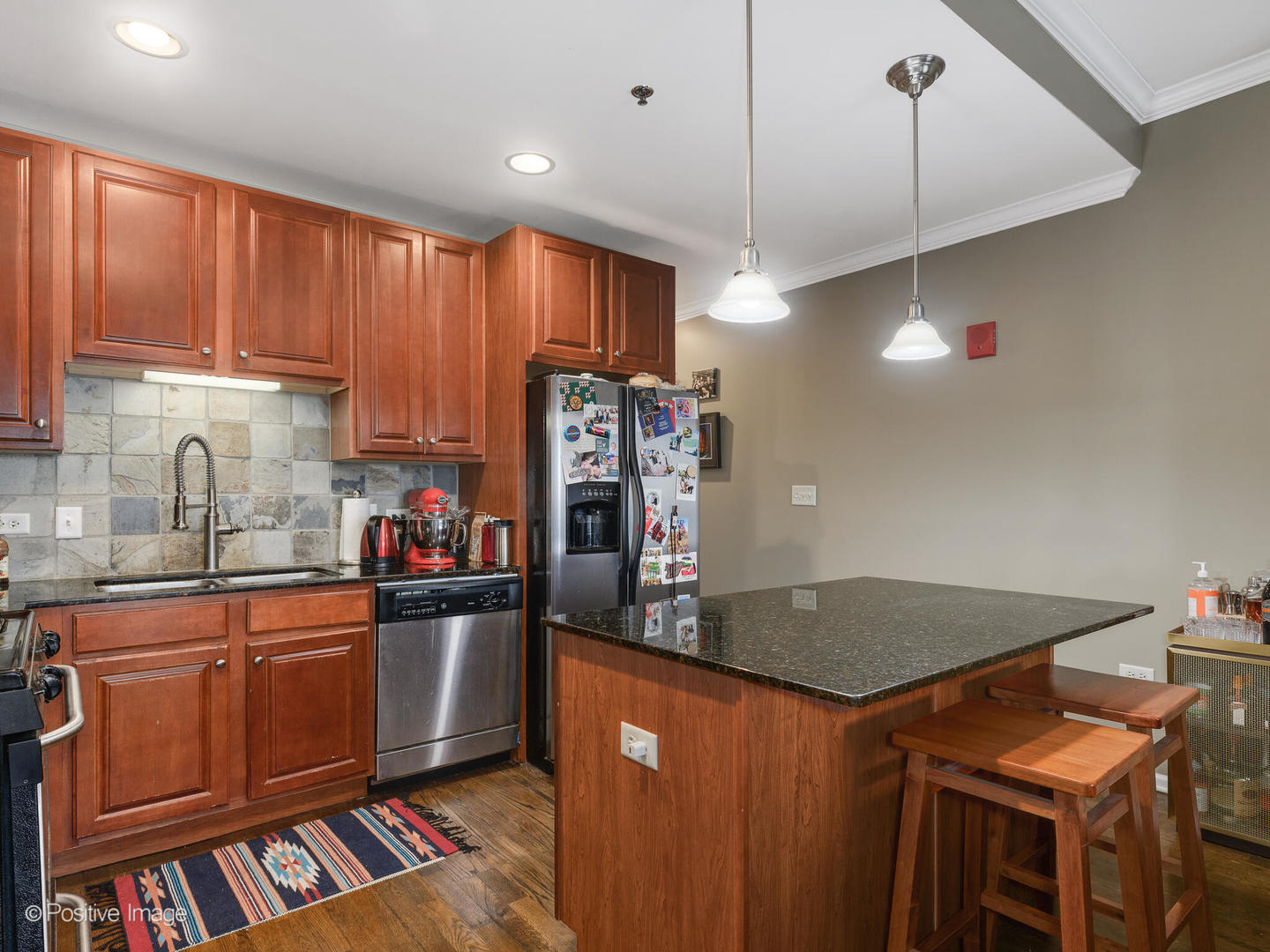 828 West Grace Street, Unit 508 Chicago, IL 60613 - Photo 4 of 15 a kitchen with stainless steel appliances granite countertop a sink a stove and a refrigerator