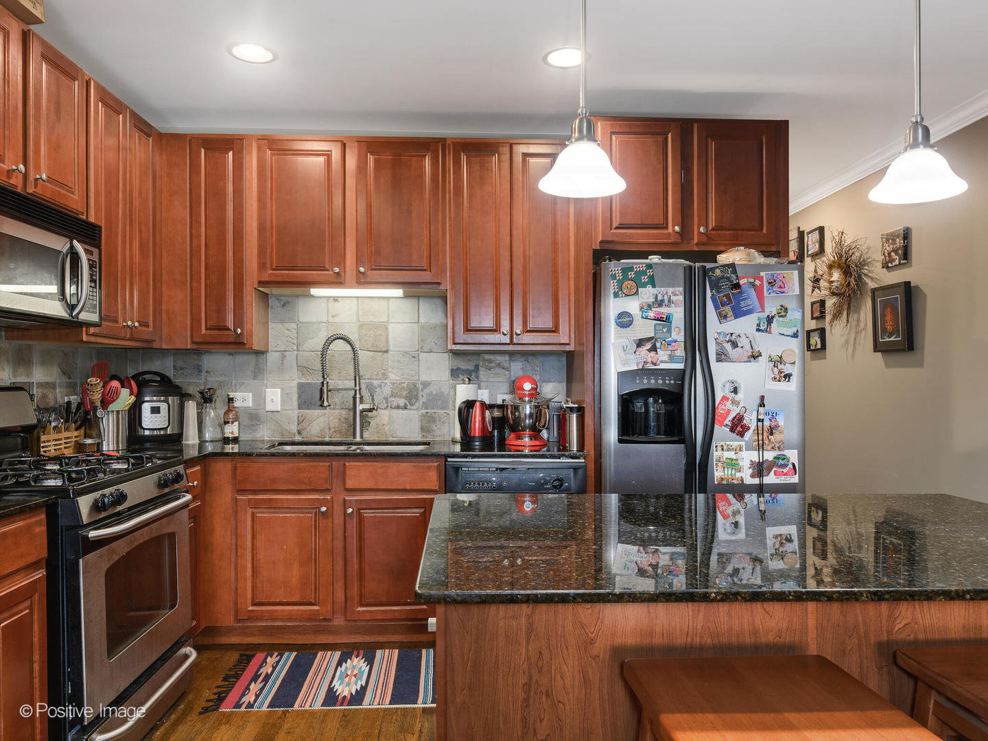 828 West Grace Street, Unit 508 Chicago, IL 60613 - Photo 5 of 15 a kitchen with stainless steel appliances granite countertop a refrigerator and a stove top oven