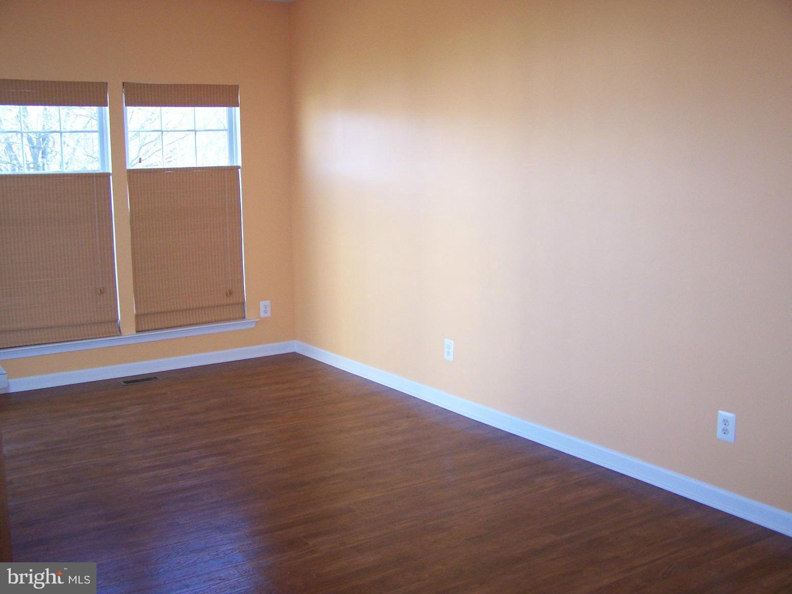 1727 Waltman Road Edgewood, MD 21040 - Photo 8 of 20 a view of an empty room with wooden floor and windows