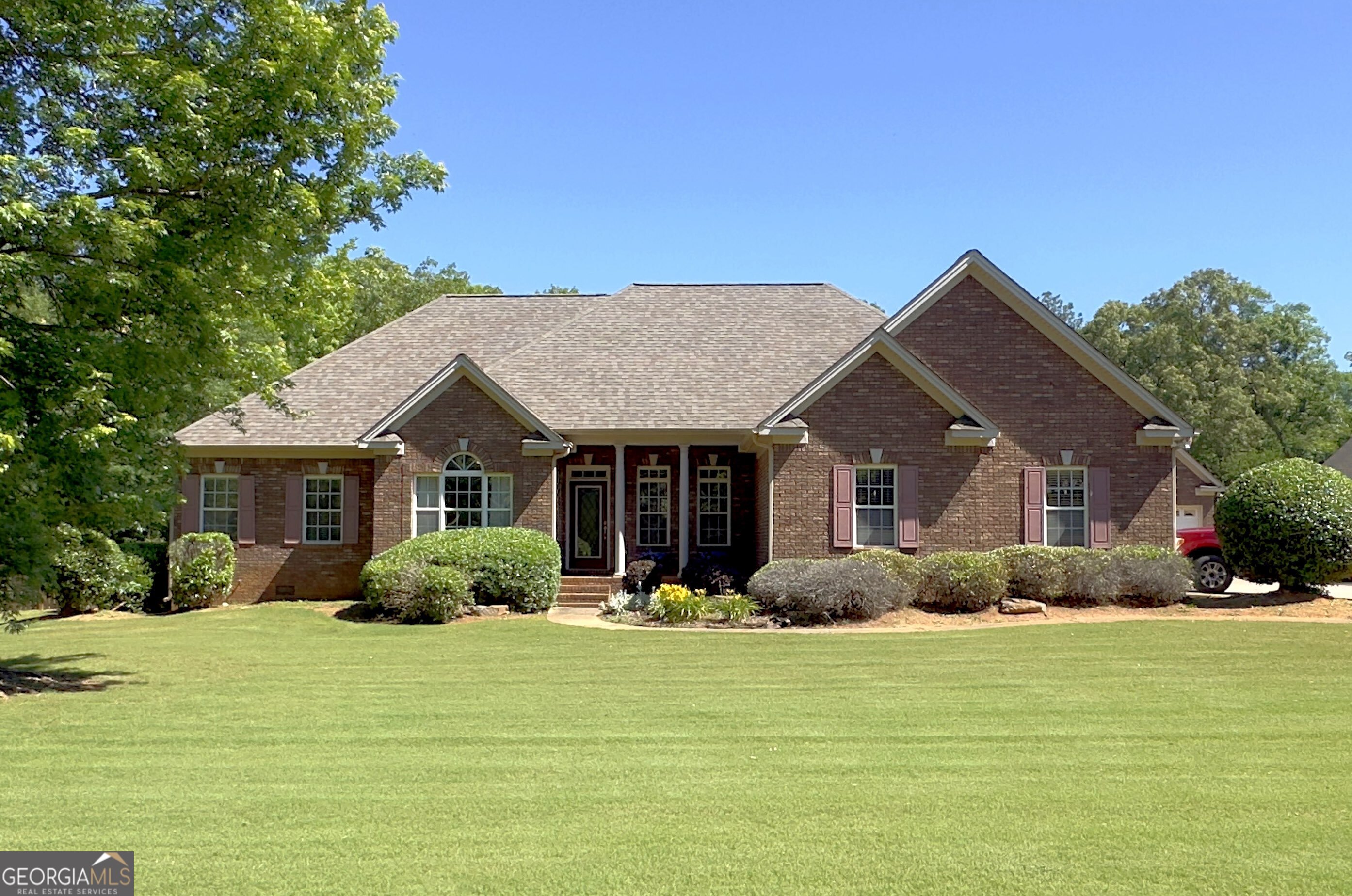 a front view of house with yard and green space