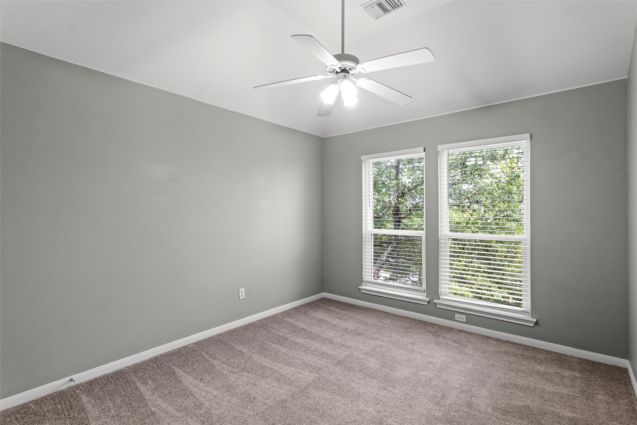 7000 Colberg Court Austin, TX 78749 - Photo 24 of 40 Second Bedroom has Plush carpeting and a ceiling fan create a comfortable atmosphere in this well-lit space.