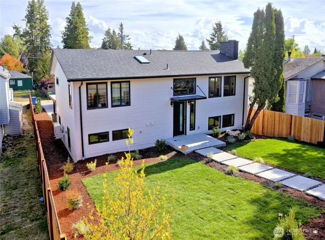 a aerial view of a house with swimming pool and a yard