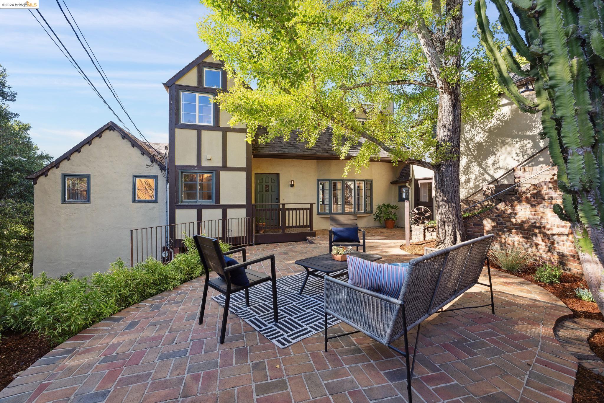 a view of a house with backyard and sitting area
