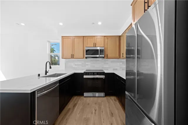a kitchen with a sink a stove and cabinets