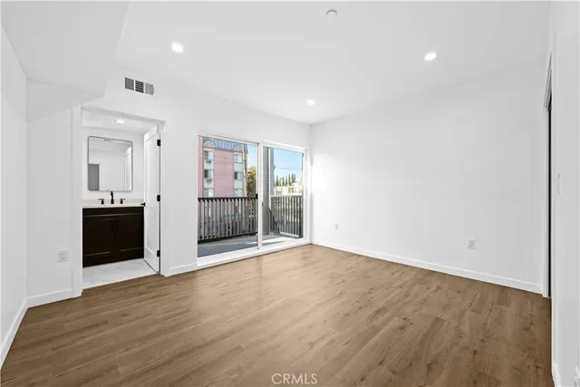 a view of a kitchen with a sink and wooden cabinets
