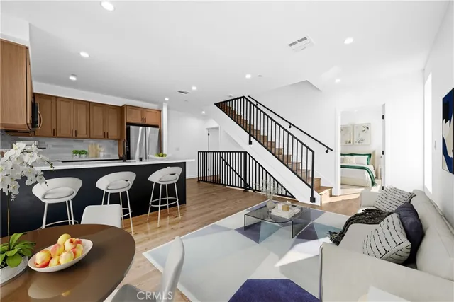 a living room with furniture and kitchen view