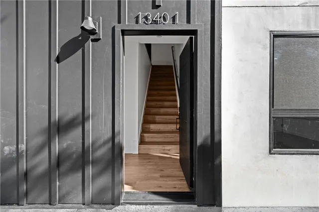 a view of a hallway with wooden floor and entryway