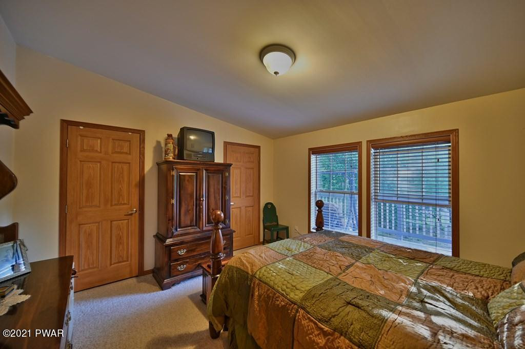 417 Northgate Road Lake Ariel, PA 18436 - Photo 29 of 91 a bedroom with a bed and wooden floor