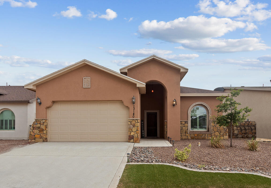 a front view of a house with garden