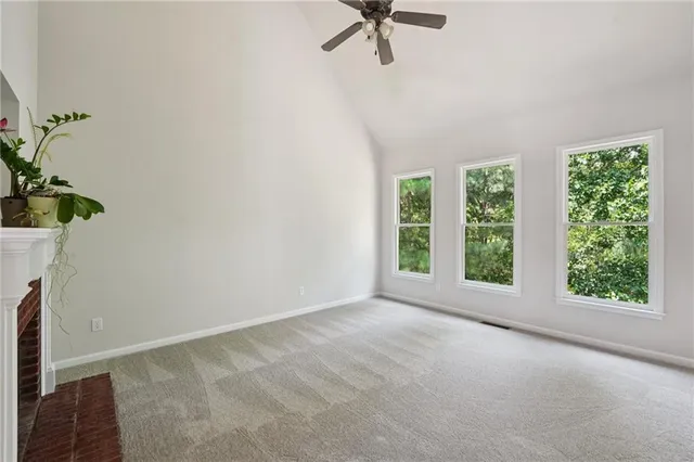 a view of a room with a window and a ceiling fan
