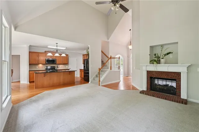 a view of kitchen and fireplace with wooden floor