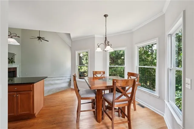 a view of a dining room with furniture window and wooden floor