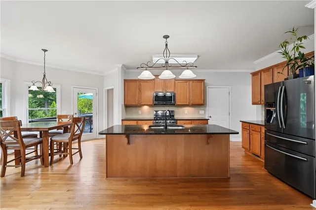 a large kitchen with lots of counter space and stainless steel appliances