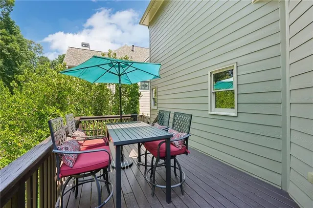 a view of deck with furniture and umbrella