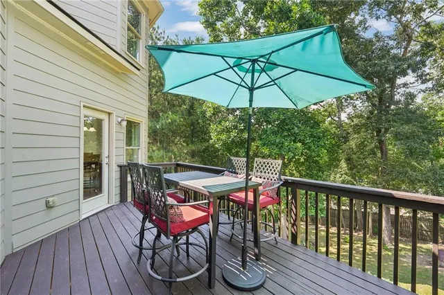 a view of deck with furniture and umbrella