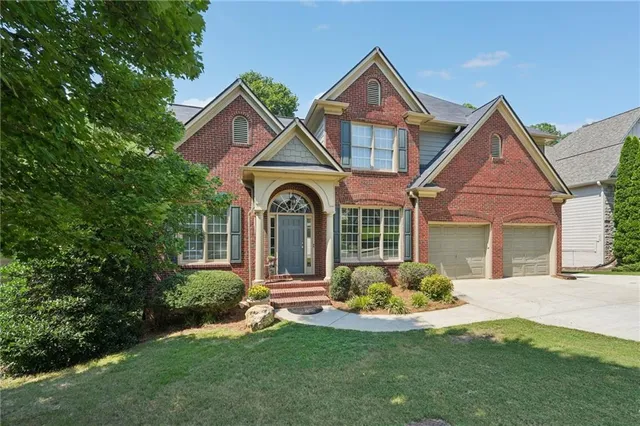 a front view of a house with a yard and porch