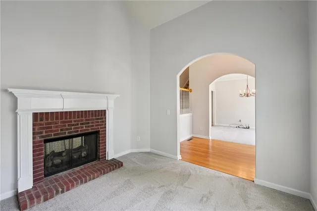 a living room with a fireplace and a rug