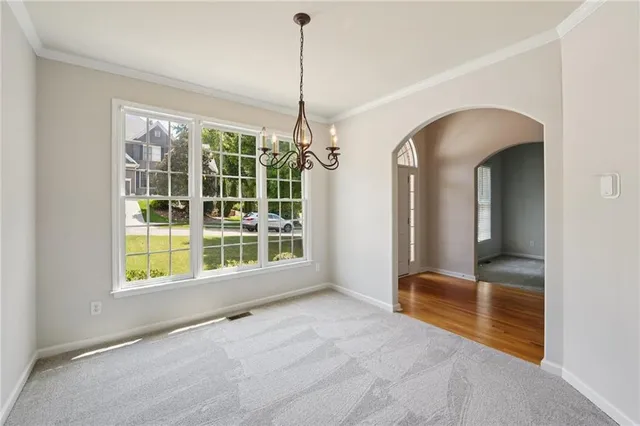 a view of an empty room with a window and balcony