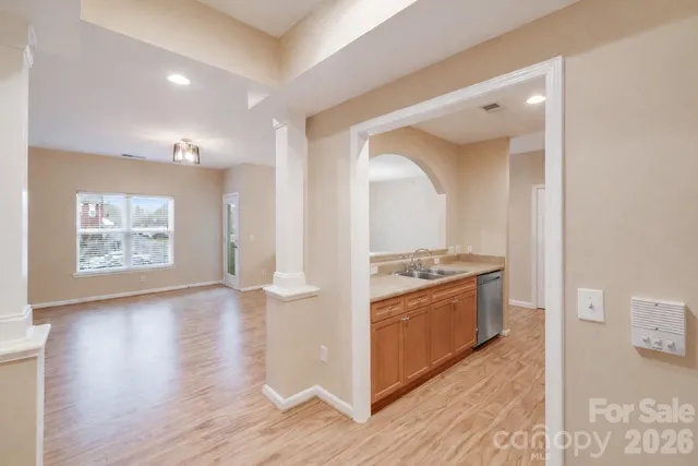 a kitchen with stainless steel appliances granite countertop a stove and a wooden floors