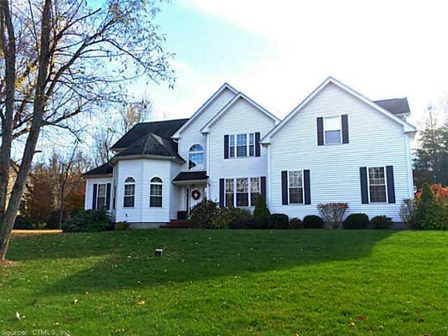 19 Royal Manor Road Somers, CT 06071 - Photo 1 of 1 a front view of a house with a garden and plants