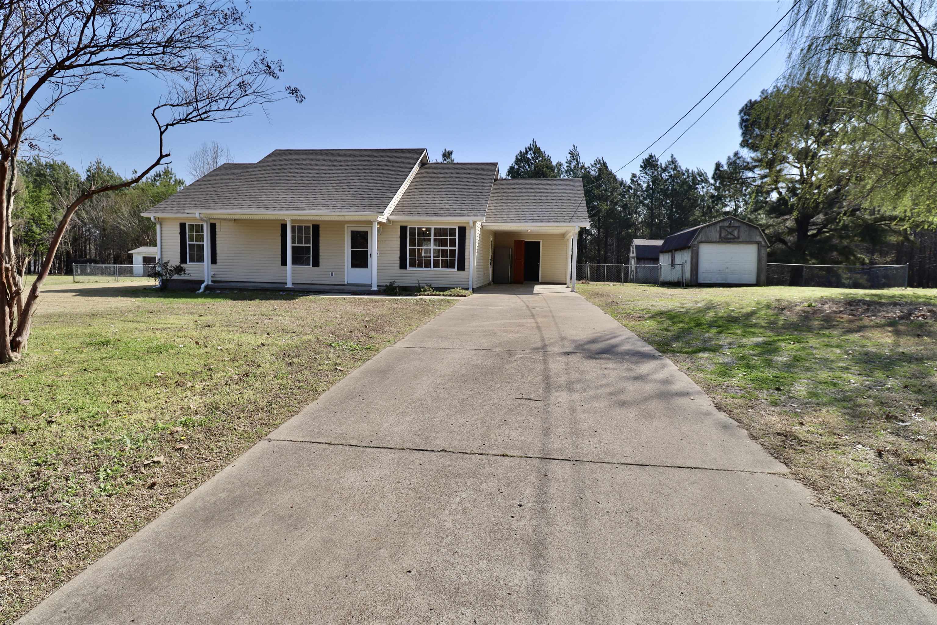1714 Conner Whitefield Road Ripley, TN 38063 - Photo 30 of 37 a front view of a house with a yard and garage