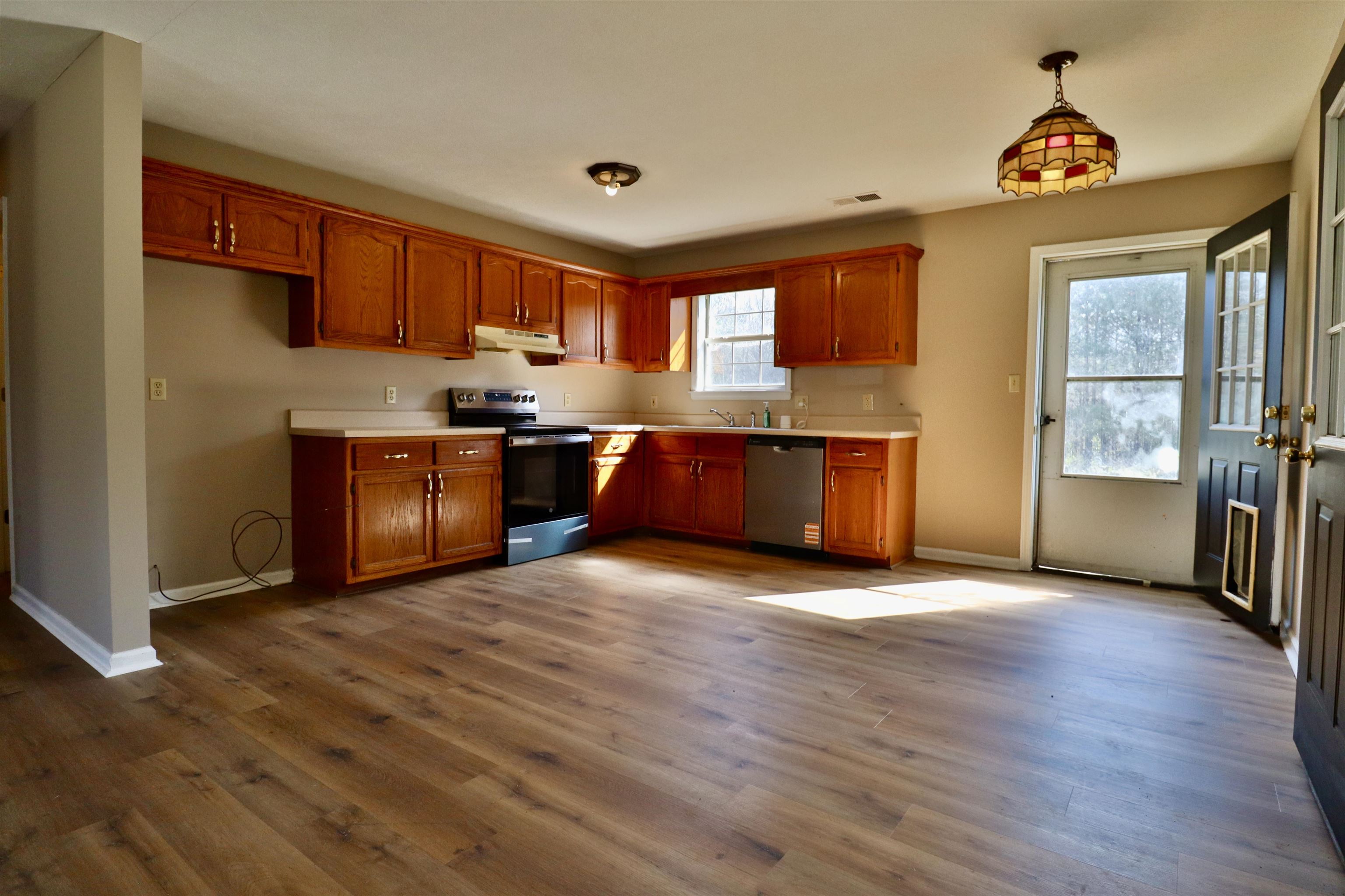 1714 Conner Whitefield Road Ripley, TN 38063 - Photo 4 of 37 a view of kitchen with stainless steel appliances granite countertop a stove top oven a sink and a microwave