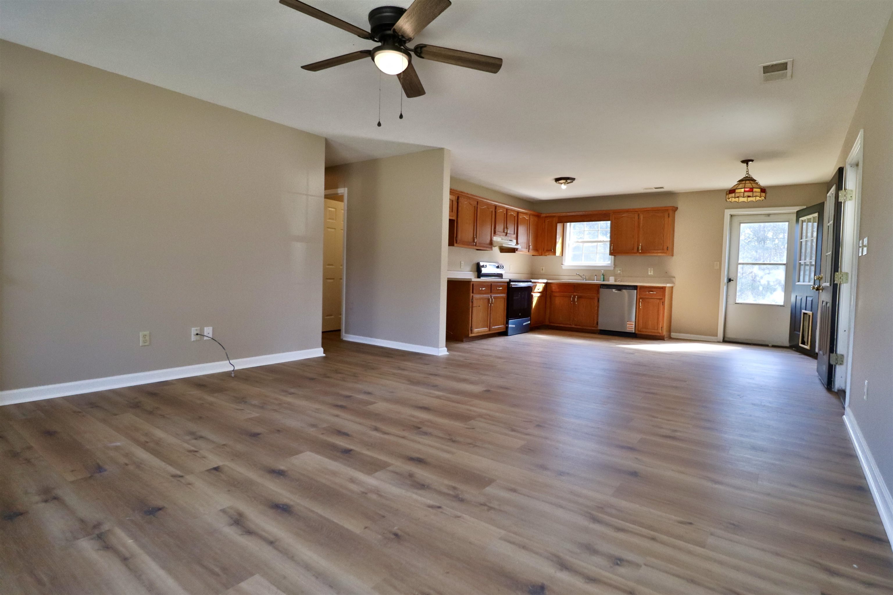 1714 Conner Whitefield Road Ripley, TN 38063 - Photo 5 of 37 a view of a livingroom with a hardwood floor and a ceiling fan