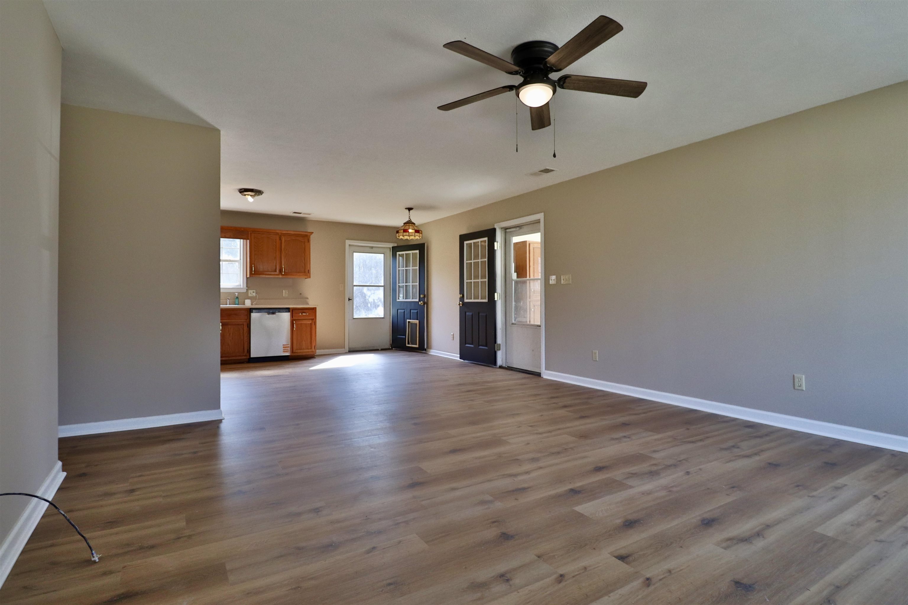 1714 Conner Whitefield Road Ripley, TN 38063 - Photo 6 of 37 a view of empty room with wooden floor and ceiling fan