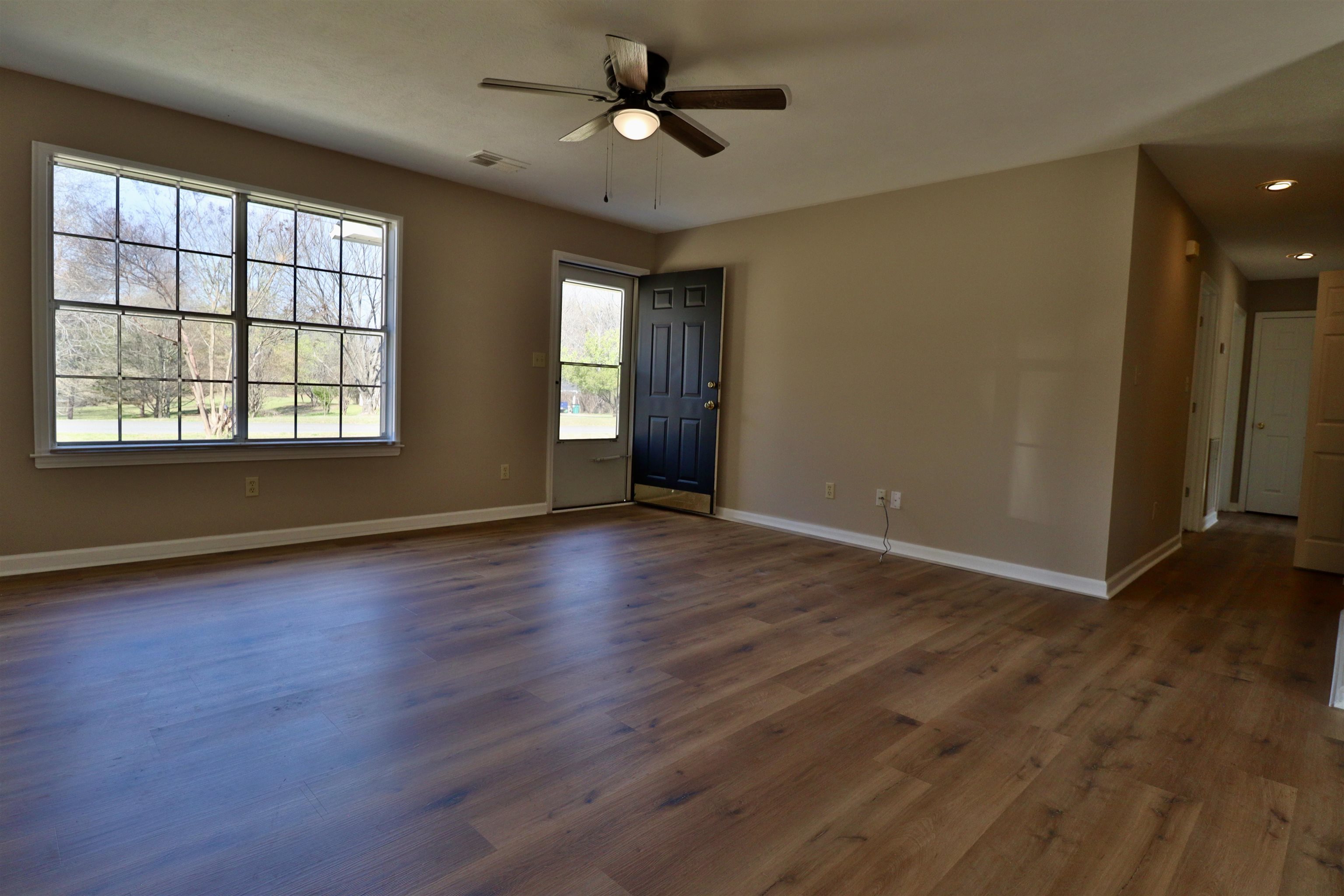 1714 Conner Whitefield Road Ripley, TN 38063 - Photo 7 of 37 an empty room with wooden floor and windows