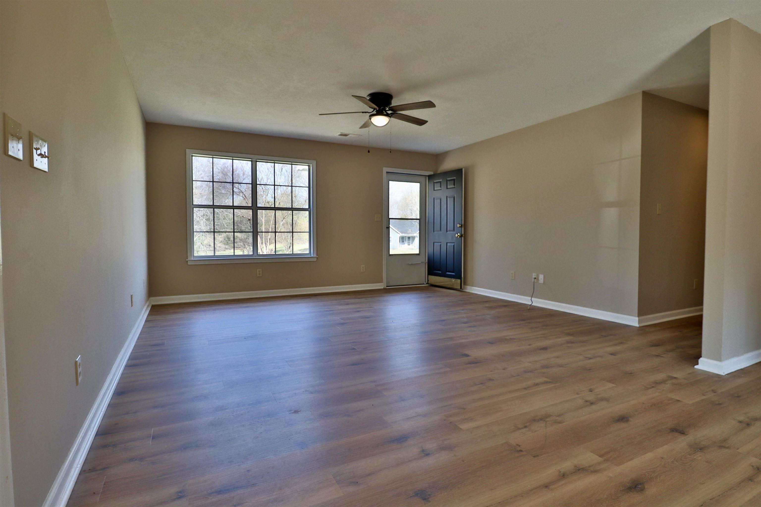 1714 Conner Whitefield Road Ripley, TN 38063 - Photo 8 of 37 an empty room with wooden floor and windows