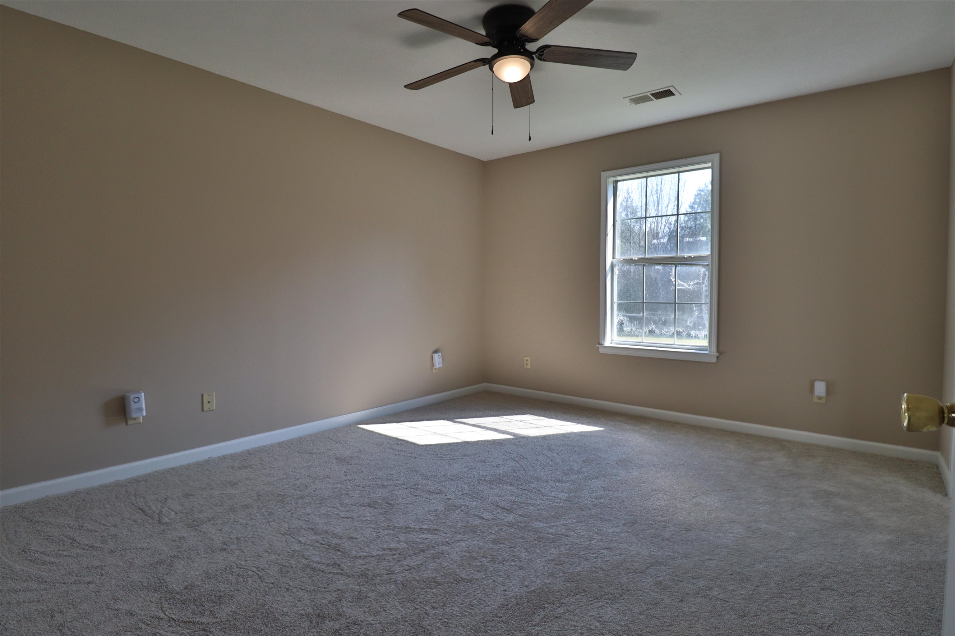1714 Conner Whitefield Road Ripley, TN 38063 - Photo 9 of 37 an empty room with a window and a fan