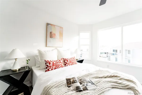 a bedroom with a bed and a lamp