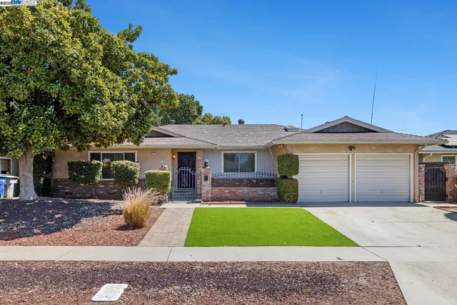 a front view of a house with a yard and porch