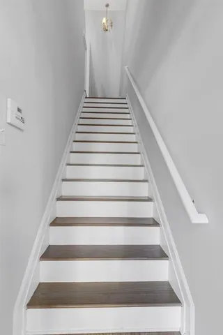 a view of empty room with a fireplace and window