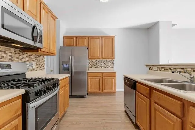 a view of a kitchen with furniture and wooden floor