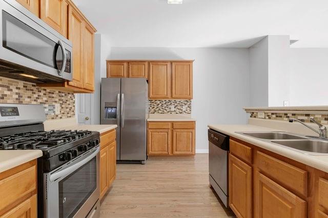 2979 Wintercrest Trace Atlanta, GA 30360 - Photo 6 of 22 a kitchen with stainless steel appliances granite countertop a sink stove and refrigerator
