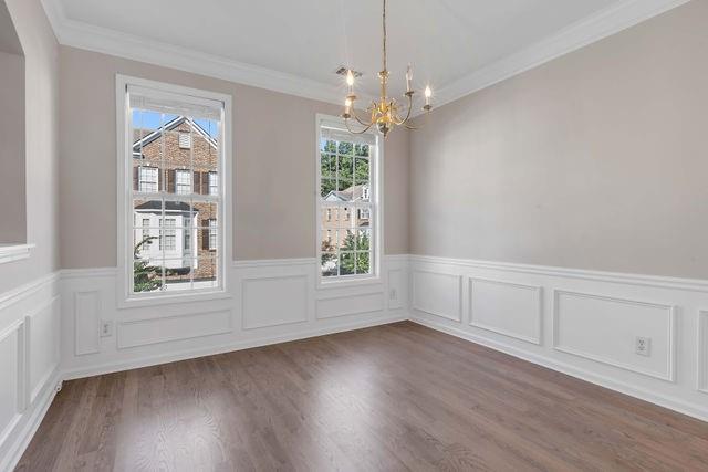 2979 Wintercrest Trace Atlanta, GA 30360 - Photo 8 of 22 an empty room with wooden floor chandelier and windows