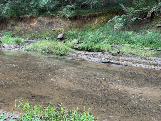 a view of a lake with beach and outdoor space