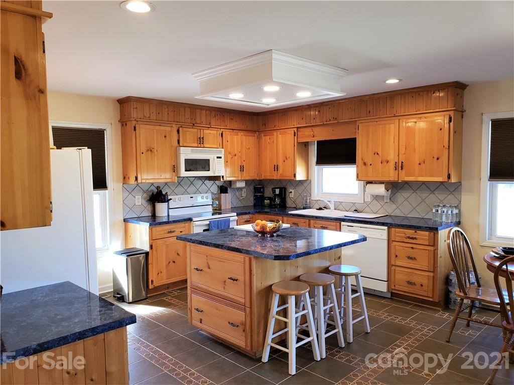 1770 Legion Road Hickory Grove, SC 29717 - Photo 13 of 48 a kitchen with a stove a sink and a refrigerator