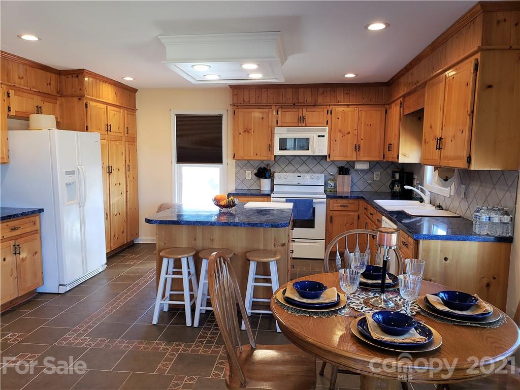 1770 Legion Road Hickory Grove, SC 29717 - Photo 14 of 48 a kitchen with stainless steel appliances a table and chairs