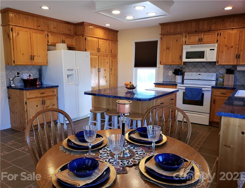1770 Legion Road Hickory Grove, SC 29717 - Photo 16 of 48 a kitchen with stainless steel appliances a table and chairs in it