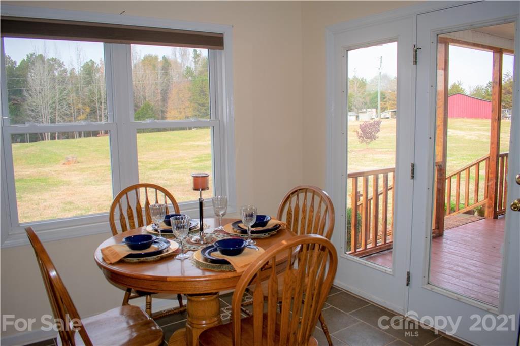 1770 Legion Road Hickory Grove, SC 29717 - Photo 17 of 48 a view of a dining room with furniture window and wooden floor