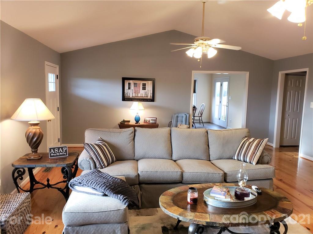 1770 Legion Road Hickory Grove, SC 29717 - Photo 10 of 48 a living room with furniture a lamp and a chandelier