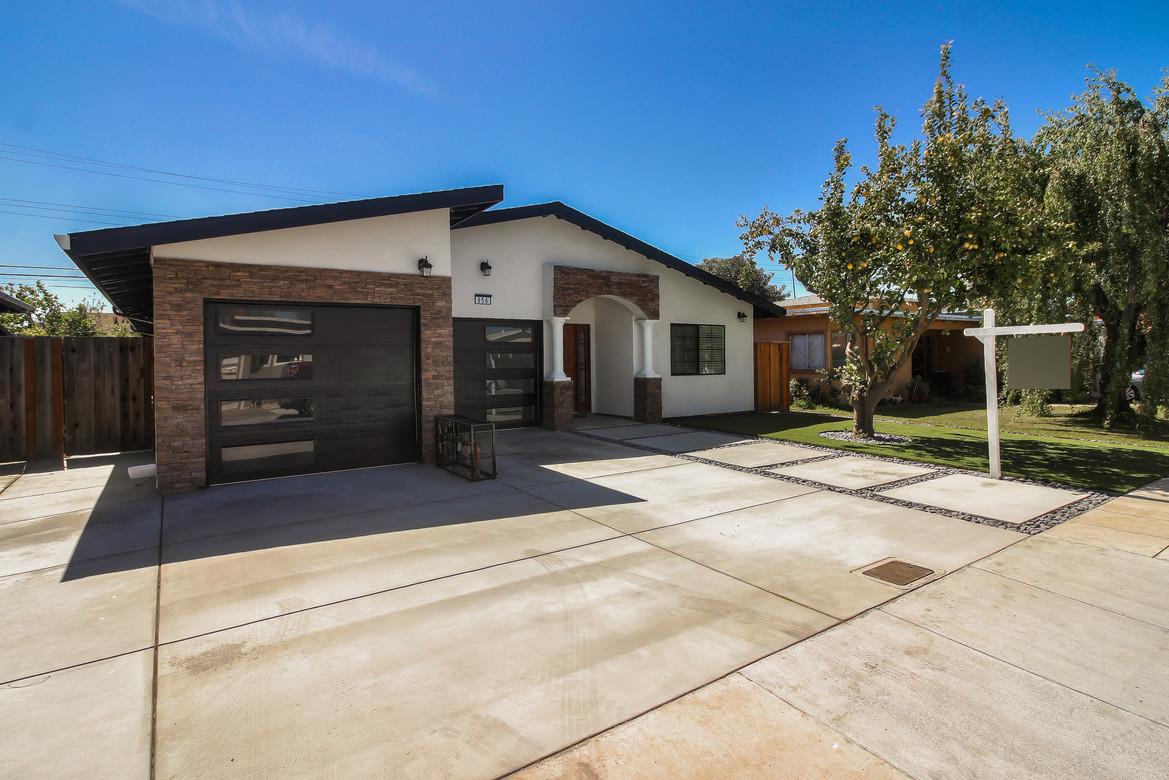 a view of a house with a backyard and a garage