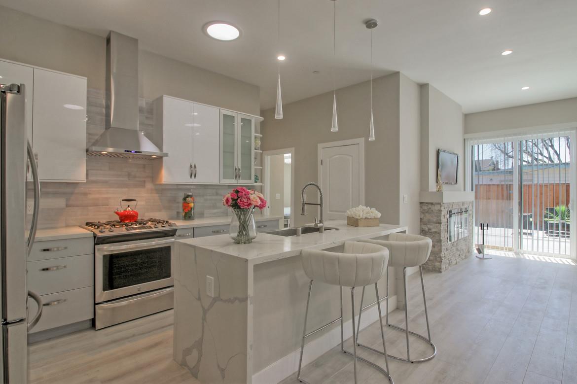 856 Howe Street San Mateo, CA 94401 - Photo 11 of 32 a kitchen with stainless steel appliances kitchen island granite countertop a sink and cabinets