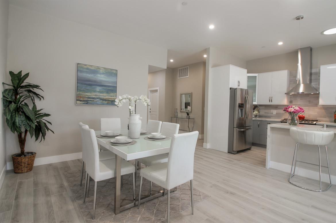 856 Howe Street San Mateo, CA 94401 - Photo 16 of 32 a dining room with stainless steel appliances kitchen island granite countertop a table and chairs