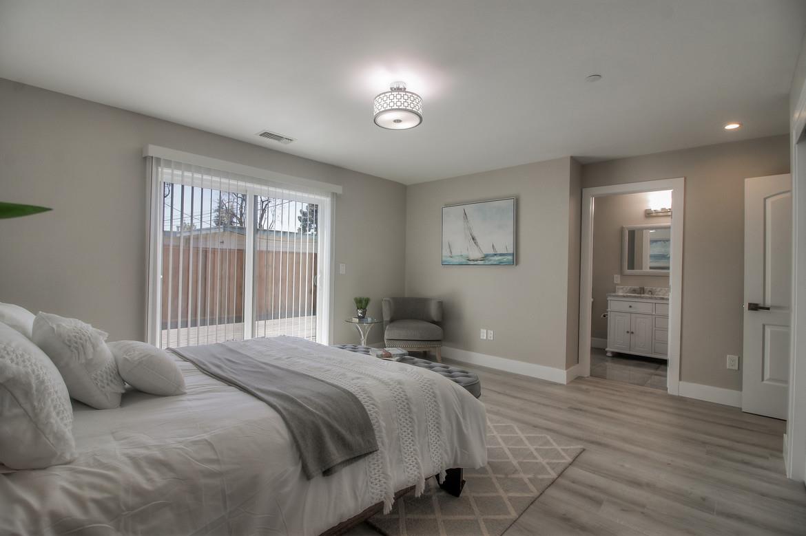 856 Howe Street San Mateo, CA 94401 - Photo 18 of 32 a bedroom with a bed and a large window