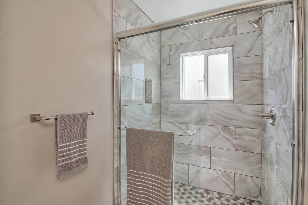 856 Howe Street San Mateo, CA 94401 - Photo 19 of 32 a bathroom with a shower and a glass door
