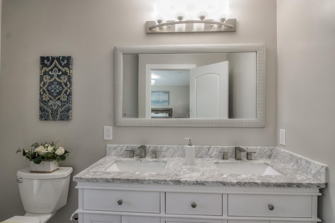 856 Howe Street San Mateo, CA 94401 - Photo 20 of 32 a bathroom with a granite countertop toilet and a sink
